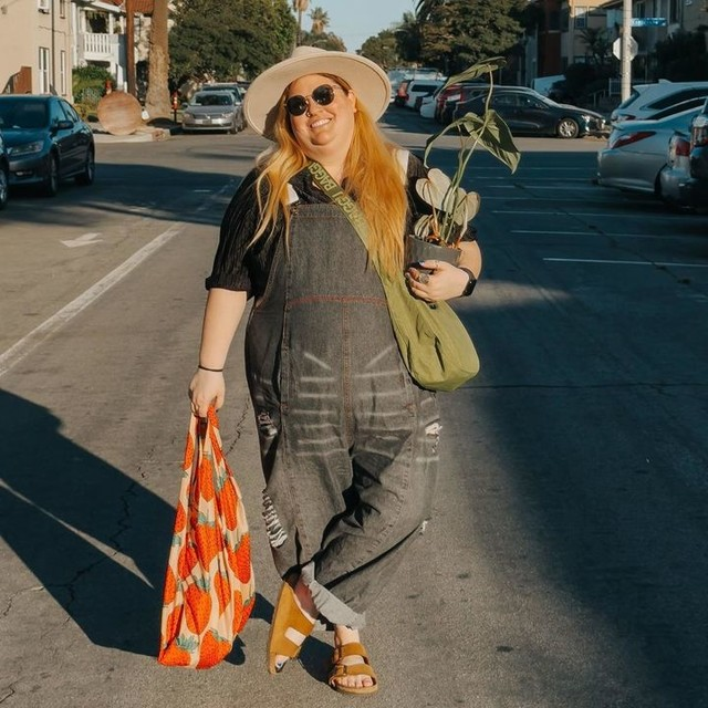 Birkenstock sandals with denim overalls on a sunny street